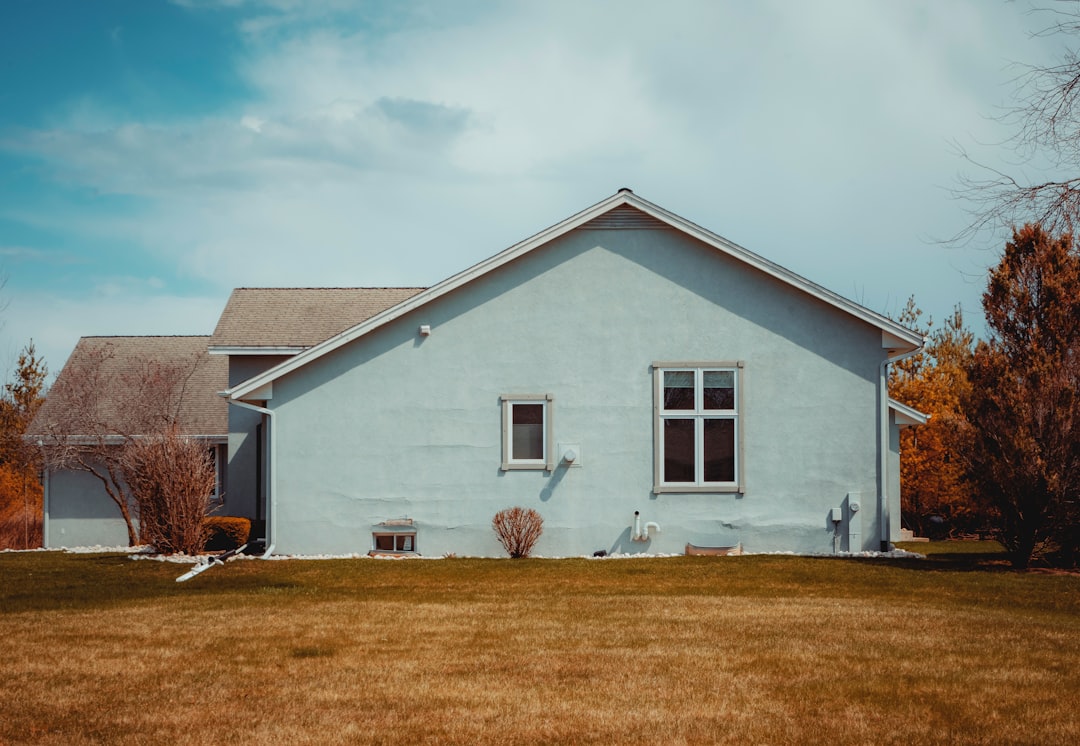 white and gray wooden house under white clouds during daytime