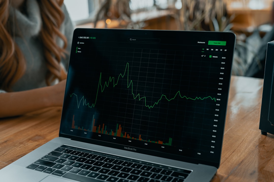 laptop showing stock chart on desk